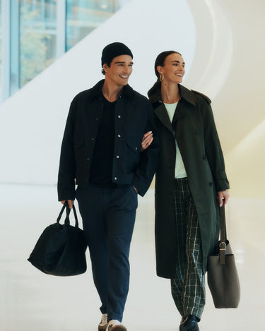 Two people walking together in an urban setting wearing Travelwear and Night And Day